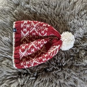Red knit hat with white detail and pom pom